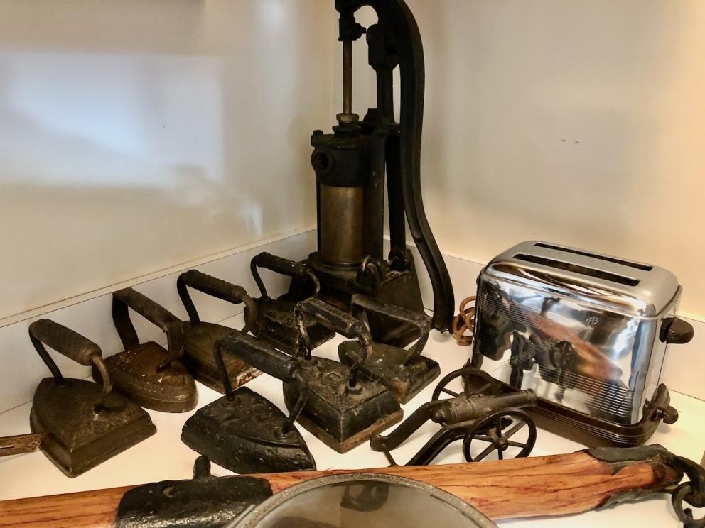 Vintage cistern pump, sad irons, toaster, cannon, and more